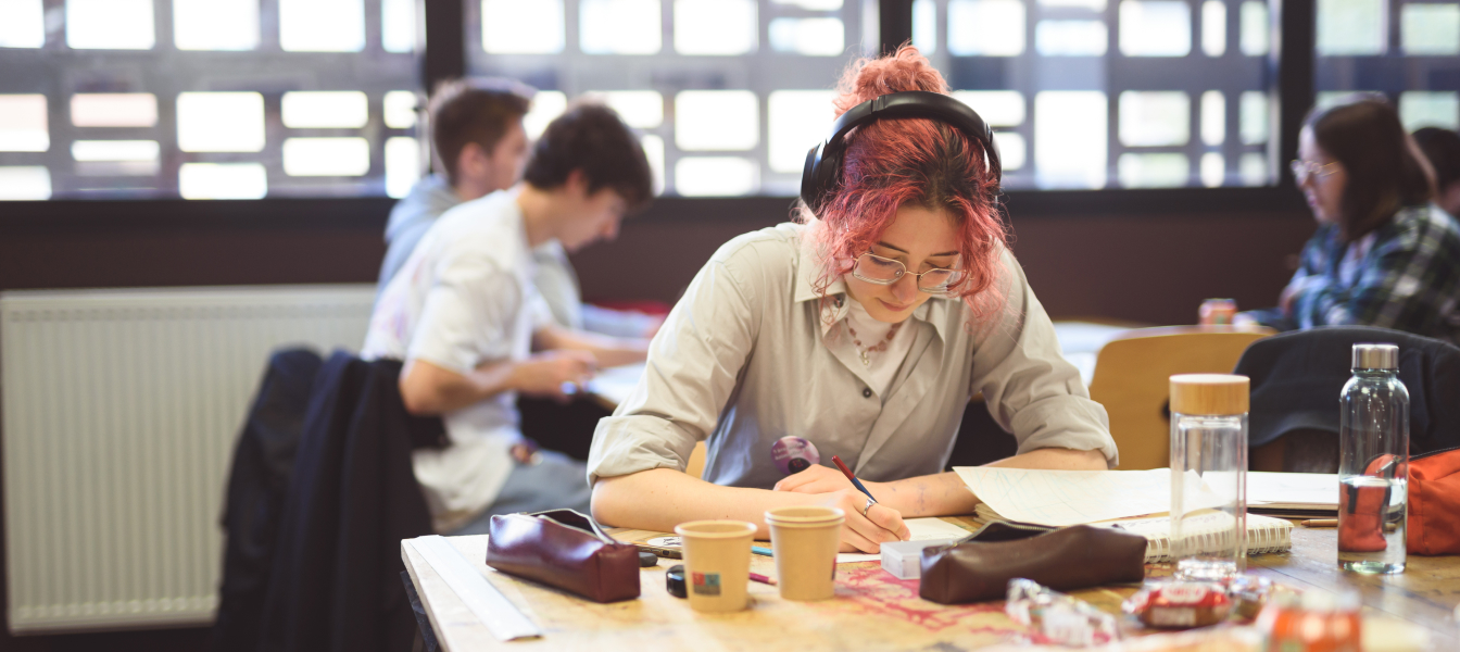 ESMA students collaborating in a creative workspace, showcasing the collaborative environment of the school’s multidisciplinary art and design programs
